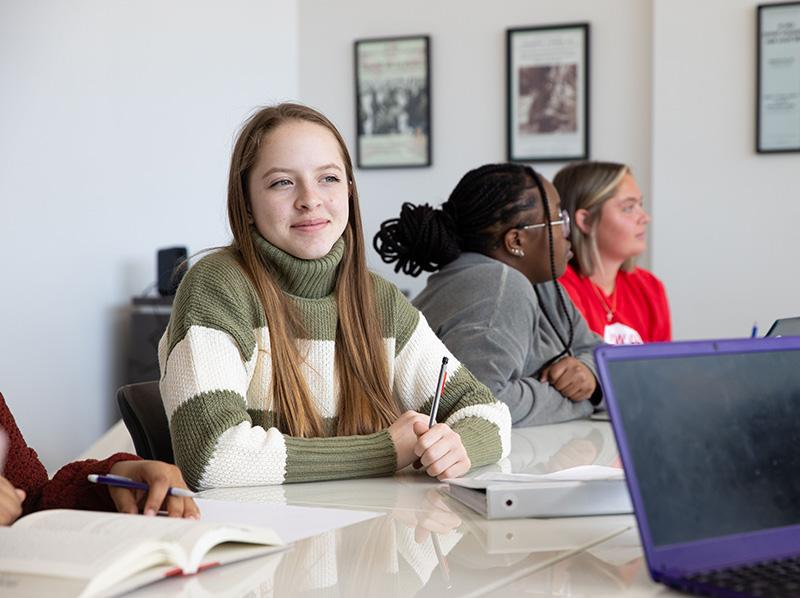 female student seated in conference room